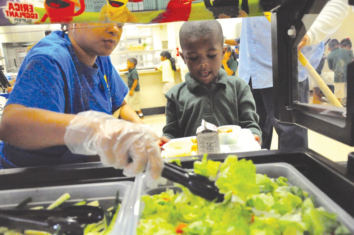 Clinton Elementary kindergartner Gary Hunter partakes of the new Super Sprowtz salad bar during lunch at his Compton school. The district teamed up with the William Morris Endeavor Foundation and Super Sprowtz to launch a new salad bar program in each of the 22 Compton Unified School District elementary schools. Begun as a pilot program at Foster Elementary School last year, the program now has expanded to encompass more than 10,000 students, with a goal of encouraging the students to choose healthier food options. (163452)